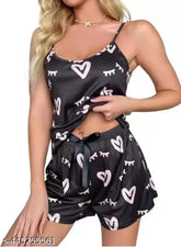 Black cotton-blend spaghetti strap pajama set for women and girls, featuring a solid print top and matching shorts
